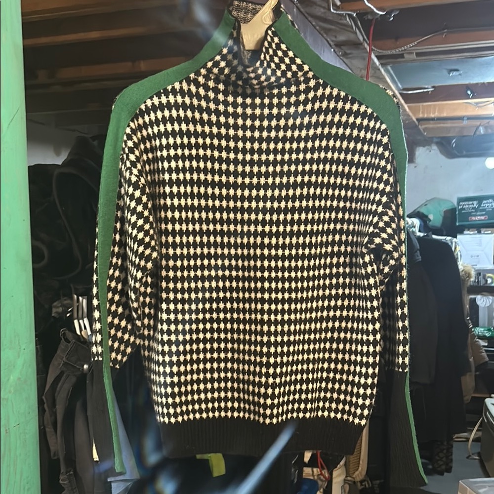 Stylish Black and White Checkered Sweater with Green Accents